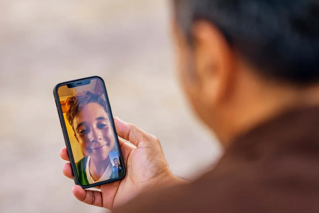 Photo of a man on a video call with his family