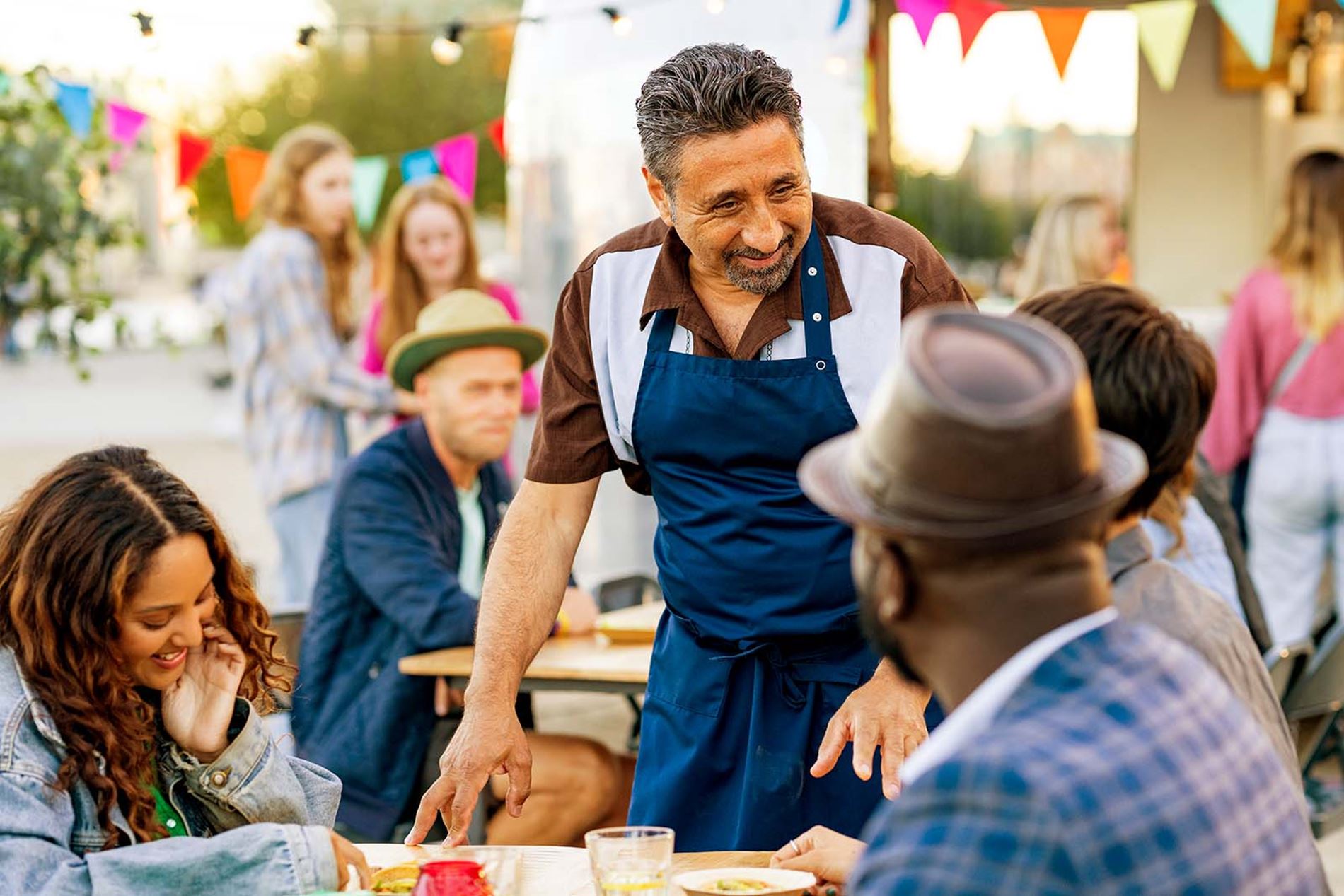 Man talking to customers outside